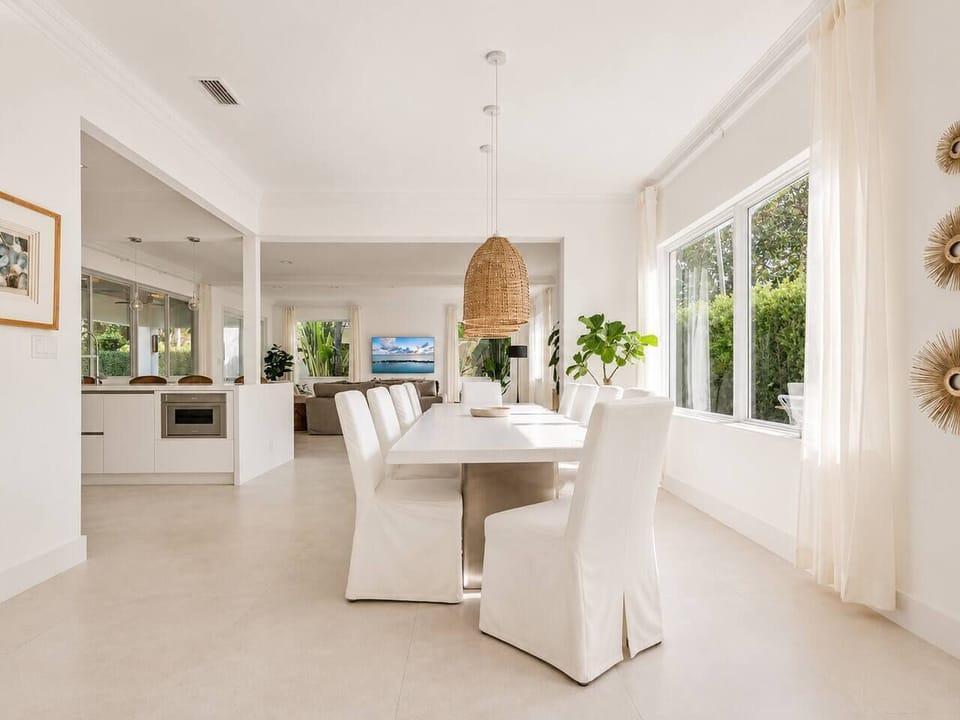 Set the table here and let the day carry on around you, with the kitchen and living room both just steps away. The tall windows pull in plenty of daylight, so no one has to eat in a dim corner.