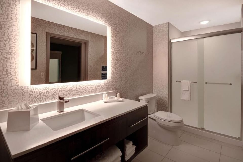 Refresh easily in a bright bathroom with sleek, modern vanity.