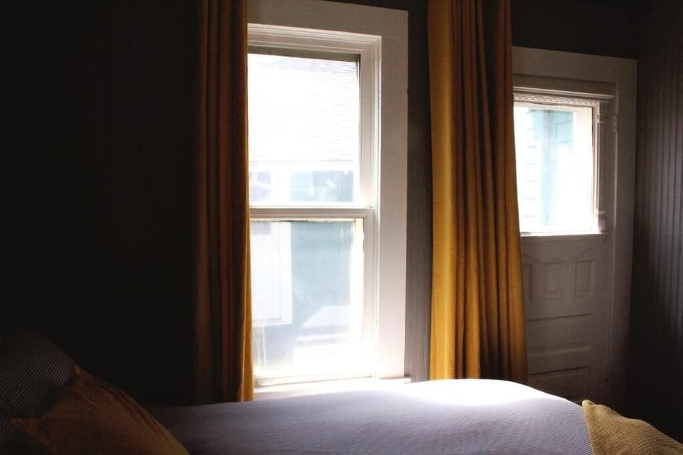 Unwind by golden drapes as daylight softly fills room.