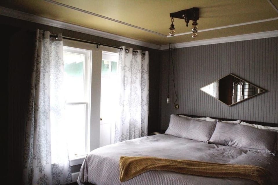 Unwind in a cozy queen bed with soft daylight.