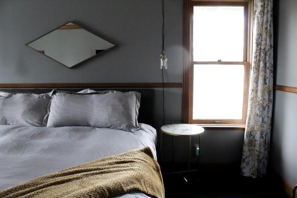 Drift off beside the window with peaceful, muted tones.