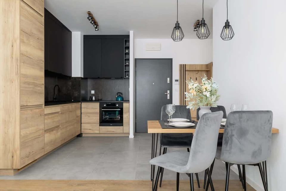 The sleek design of the kitchenette blending seamlessly with the living area.