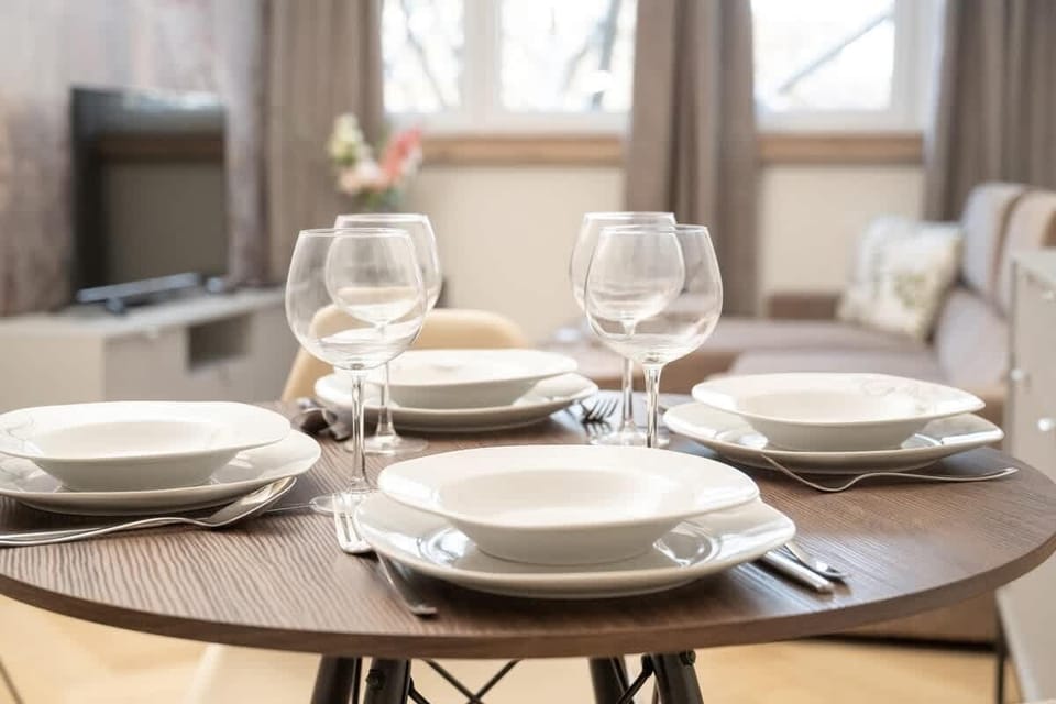 A close-up of the beautifully set dining table showcasing fine china and crystal glassware, creating a sophisticated atmosphere.
