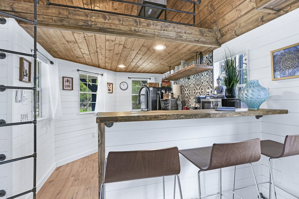 Back down from the loft is the kitchen which features bar seating.