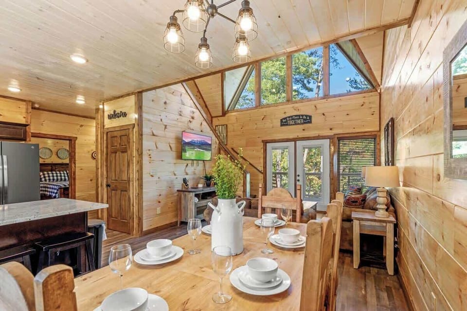 Entrance view of the dining table, living room with vaulted ceiling.  