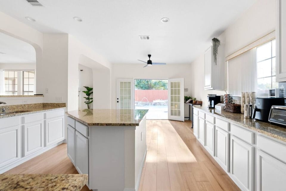 House 1 - Cooking made easy in our kitchen with a sleek center island. Spacious, clean, and ready for your culinary adventures.