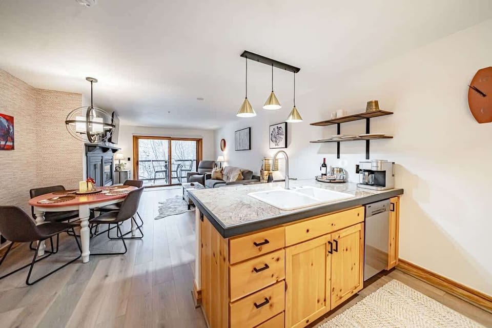 Well-lit open kitchen and dining area.