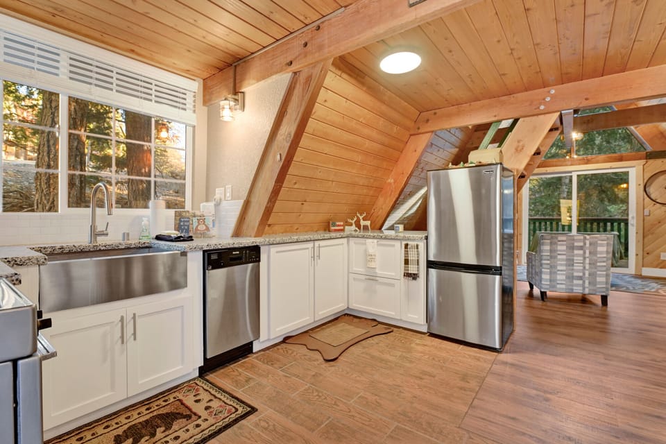 Fully equipped cabin kitchen with ample cabinetry, stove, fridge, microwave, and coffee maker—perfect for cooking meals, morning coffee, and feeling right at home on your stay.