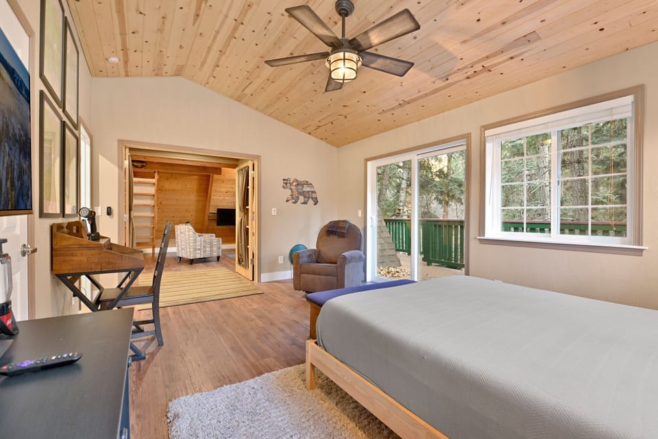 Peaceful cabin bedroom with plush bedding, and beautiful views—ideal for restful nights, cozy mornings, and a relaxing mountain escape.