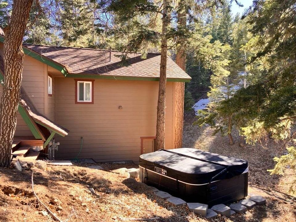 Relax in the outdoor hot tub area, a cozy and peaceful space perfect for unwinding and enjoying fresh air after a long day.