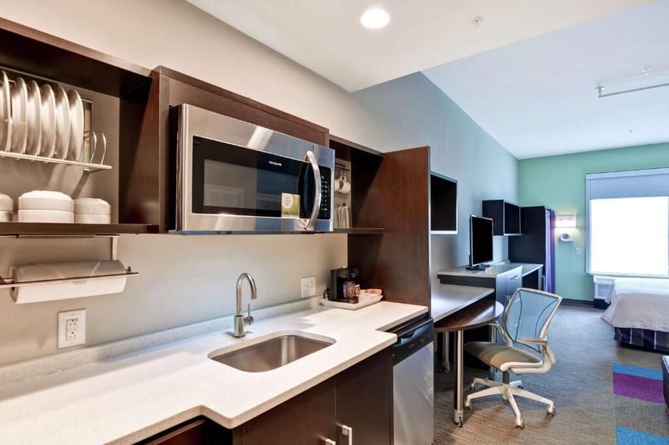 Enjoy easy meals with kitchenette sink, microwave, and dining setup.