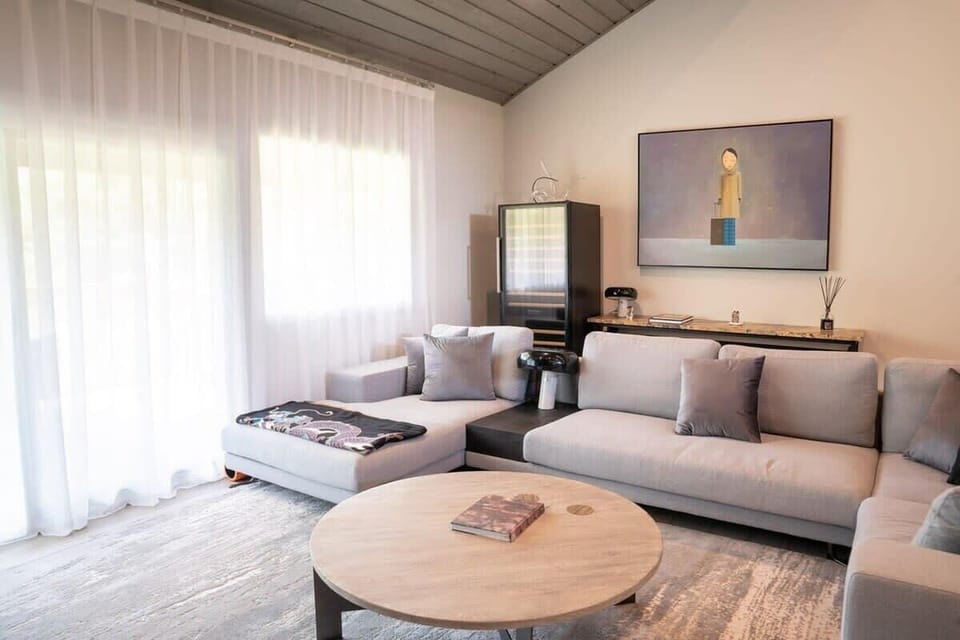 Living Room: Relax in our cozy and inviting living space with comfortable seating and ample natural light, perfect for unwinding after your fun day out.