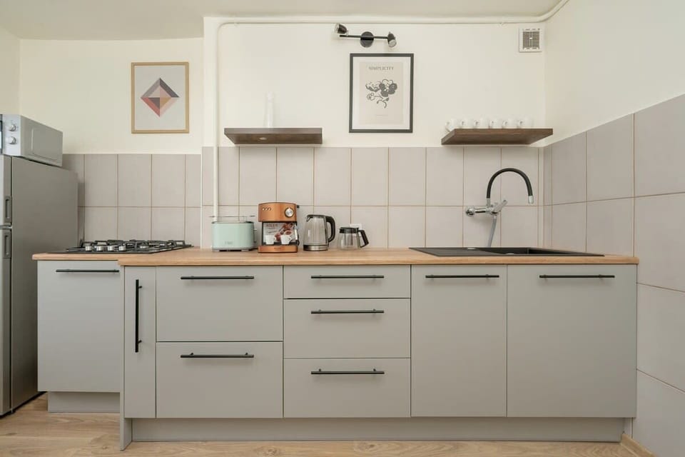 A modern kitchen with full-length cabinetry, built-in appliances, and a sleek design.