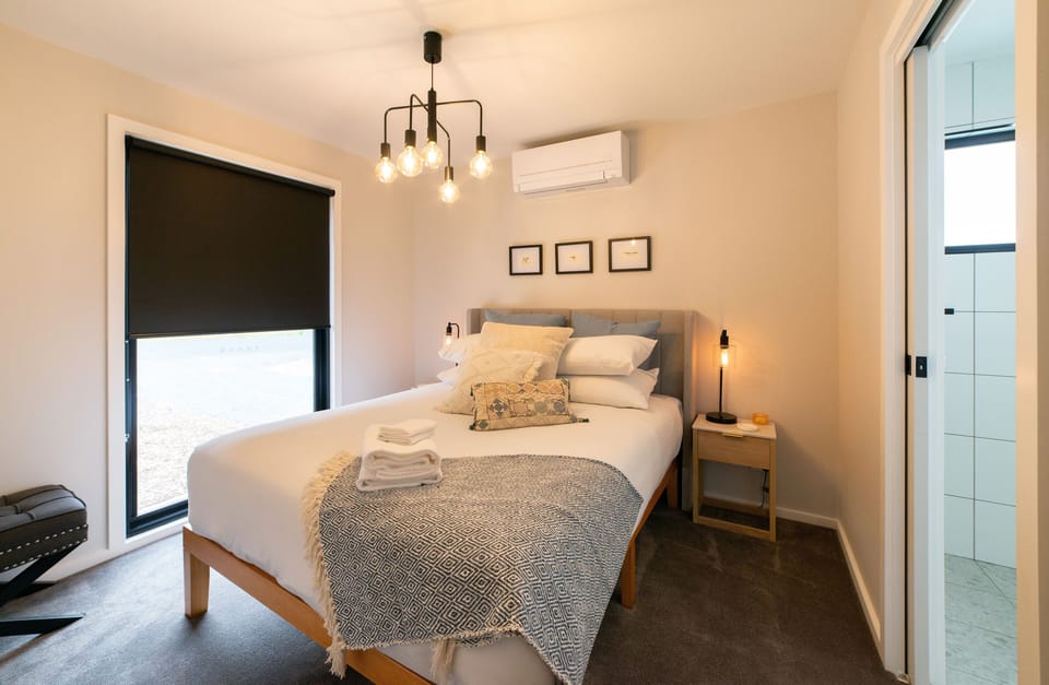 The light-filled primary bedroom offers a queen-size bed and pristine ensuite for privacy.