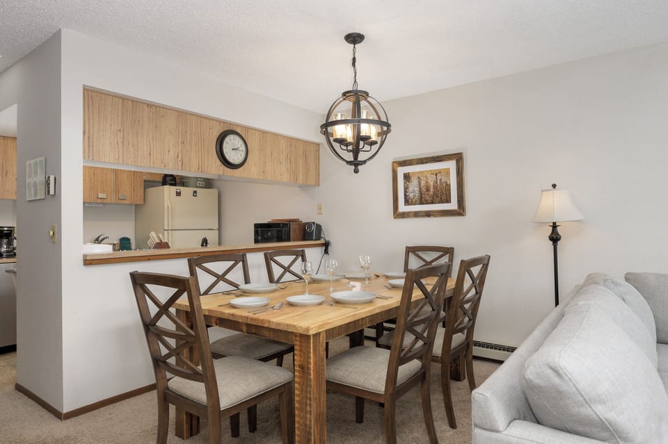 Your open dining space flows beautifully into the kitchen, perfect for shared meals under warm pendant lighting.