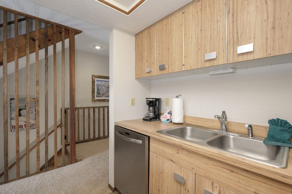 Whip up your morning coffee in this bright kitchen with modern appliances and warm wood finishes that create a cozy home-away-from-home feel.