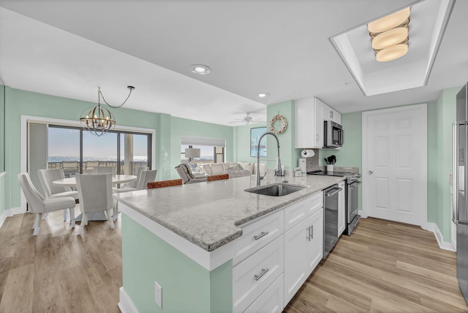 Your modern kitchen flows seamlessly into the dining area, where soothing mint walls and granite counters create the perfect space for preparing meals together.