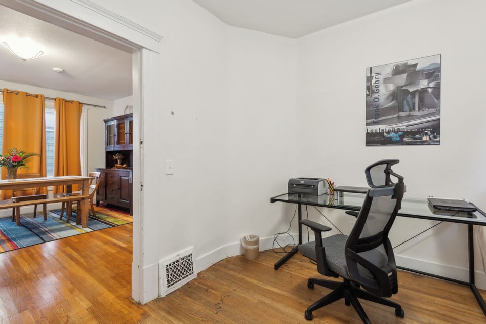Office with a couch that folds into a bed.