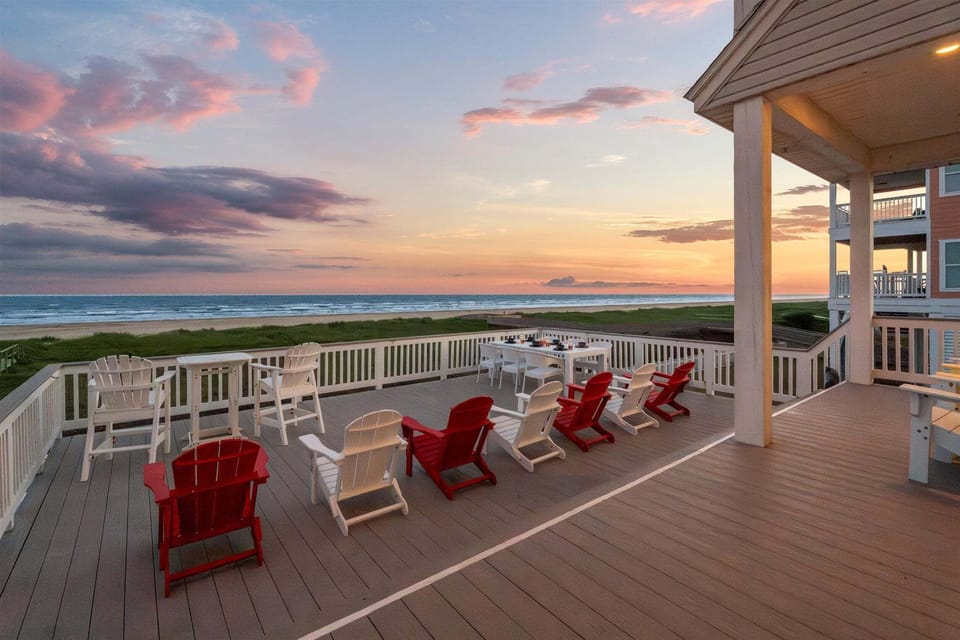 Elevated Gulf Coast beach home with wraparound balconies, covered ground-level entertainment space, and spacious backyard near the beach.