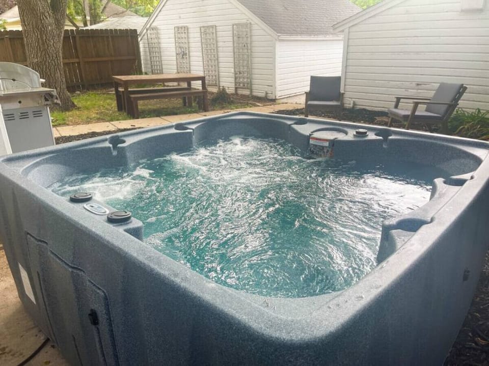 Indulge in relaxation in the shared hot tub outside, offering a serene oasis after a day of exploring. Perfect for unwinding under the stars.