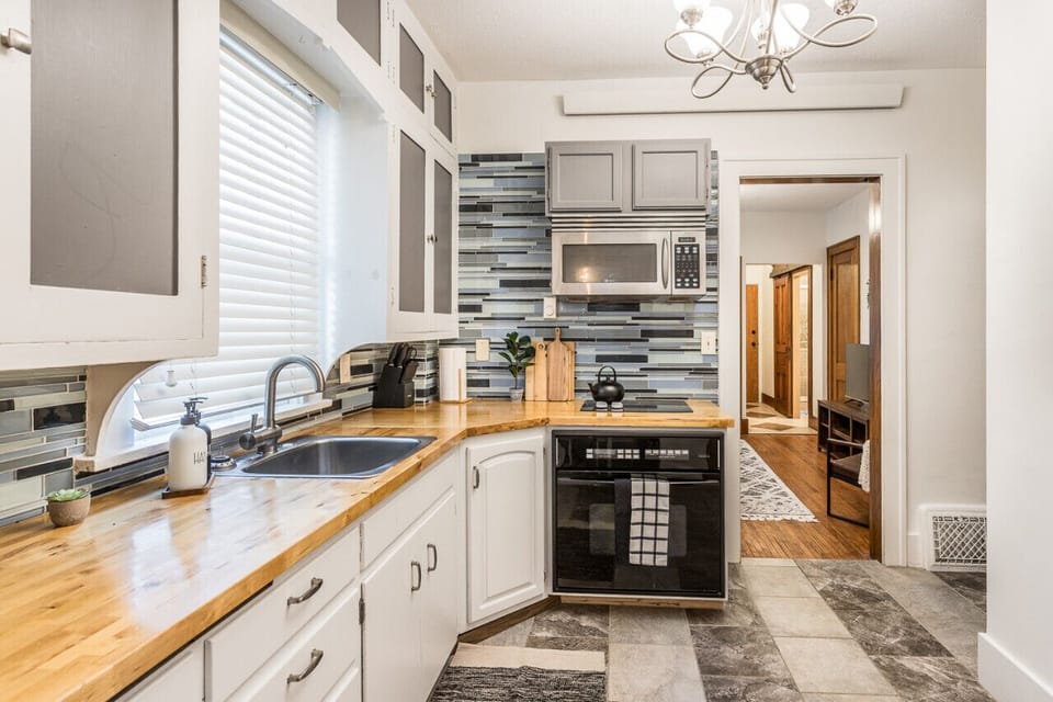 The kitchen at The Prairie Loft combines modern design with rustic charm, offering a stylish and functional space for culinary endeavors and gathering with loved ones.