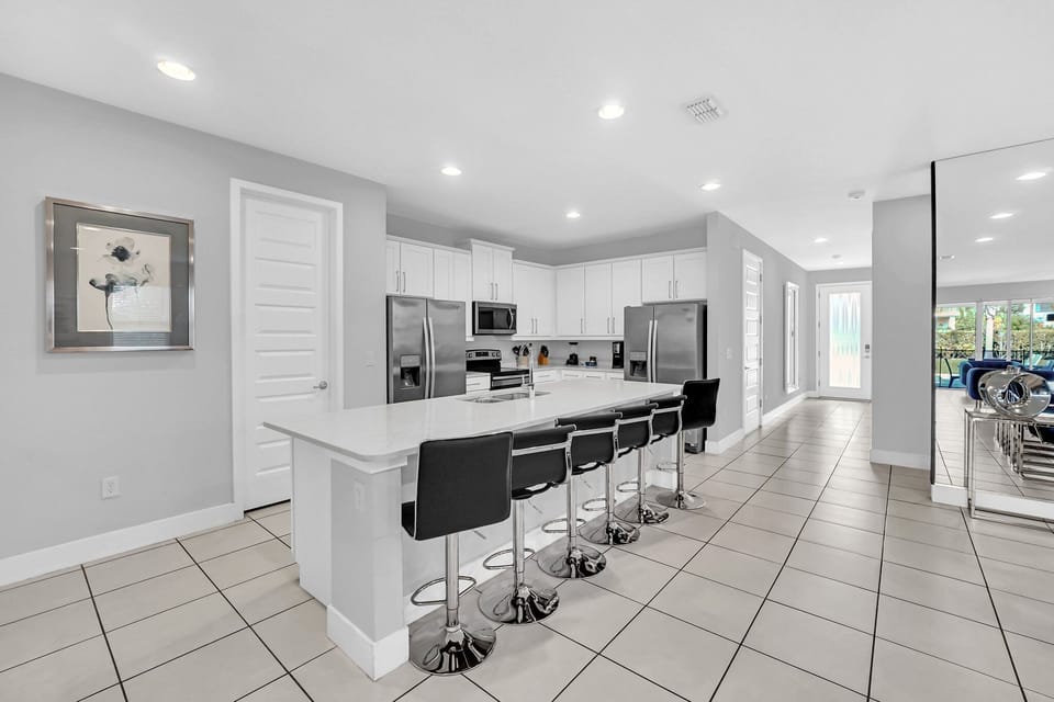 Modern and spacious kitchen with a large island, sleek appliances, and bar seating, perfect for casual dining or enterta