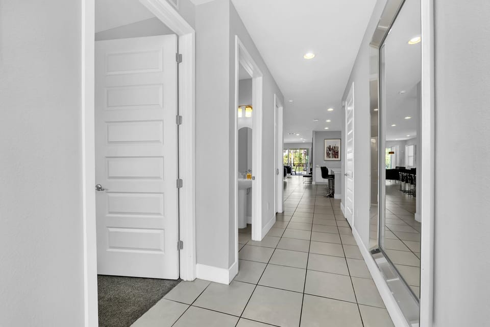 Bright hallway leading to a spacious, modern dining area, ideal for entertaining and family gatherings.