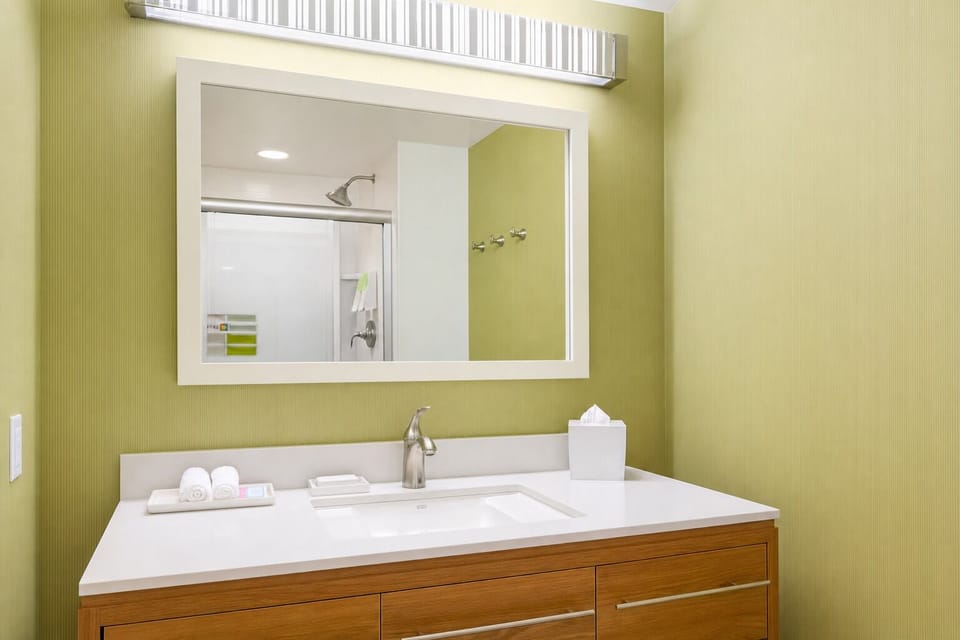 Freshen up at a sleek vanity with bright, flattering lighting.
