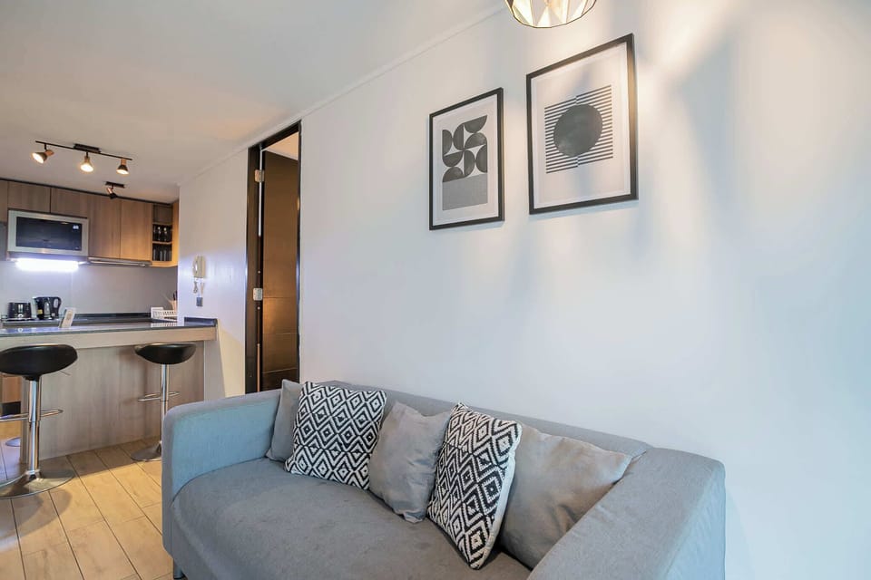 Cozy living space with modern decor and a convenient kitchen bar, perfect for relaxing after exploring the city.