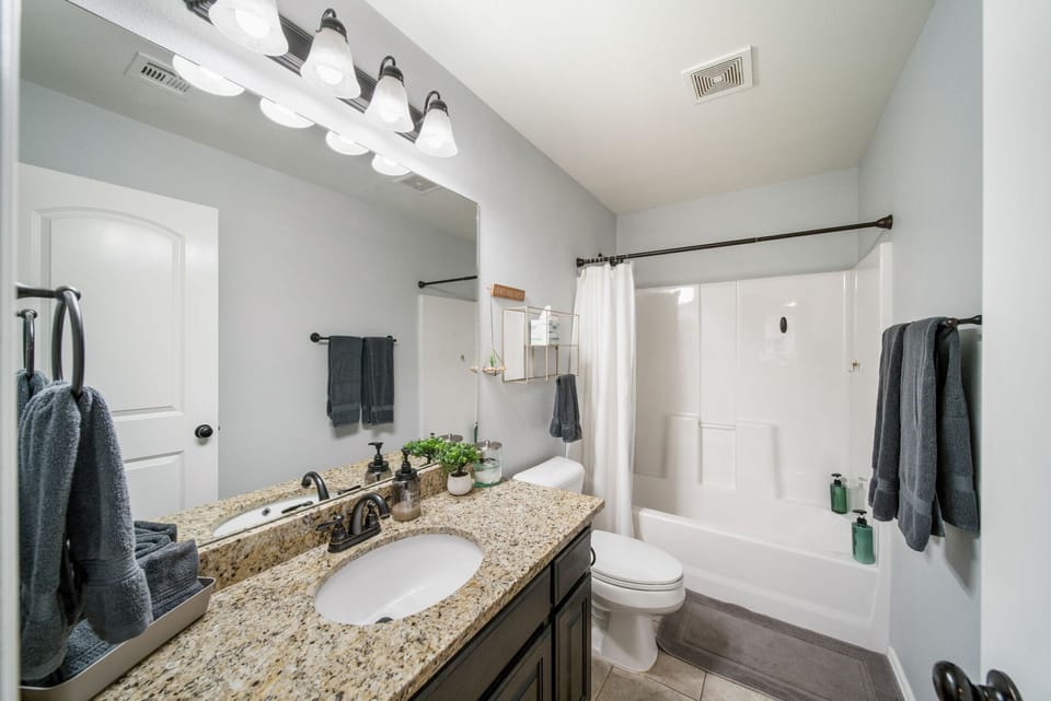 Upstairs hall bathroom is large and has lots of counter space. Plenty of fluffy towels for everyone.   Bathtub and shower  and has included shampoo, conditioner and body wash.