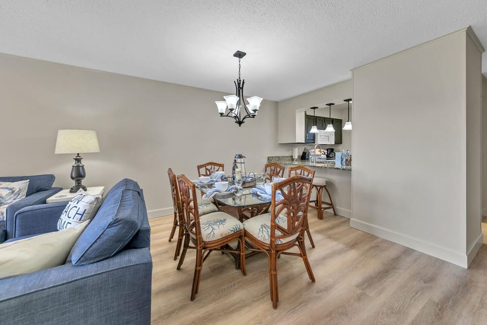 Gather around your elegant dining table beneath the warm chandelier glow, while the open kitchen invites culinary adventures.