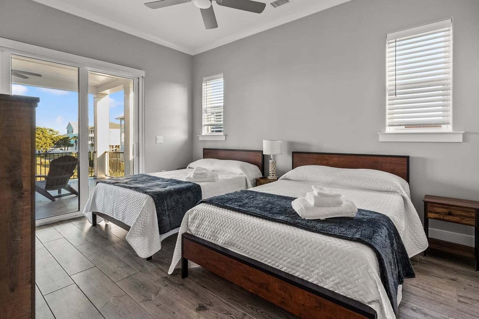 Bedroom with two beds and sliding doors to the balcony at Vistas Del Sol in North Myrtle Beach