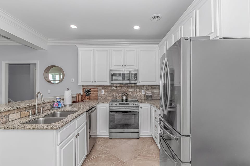 The kitchen is fully stocked with high quality cookware, dishware and silverware