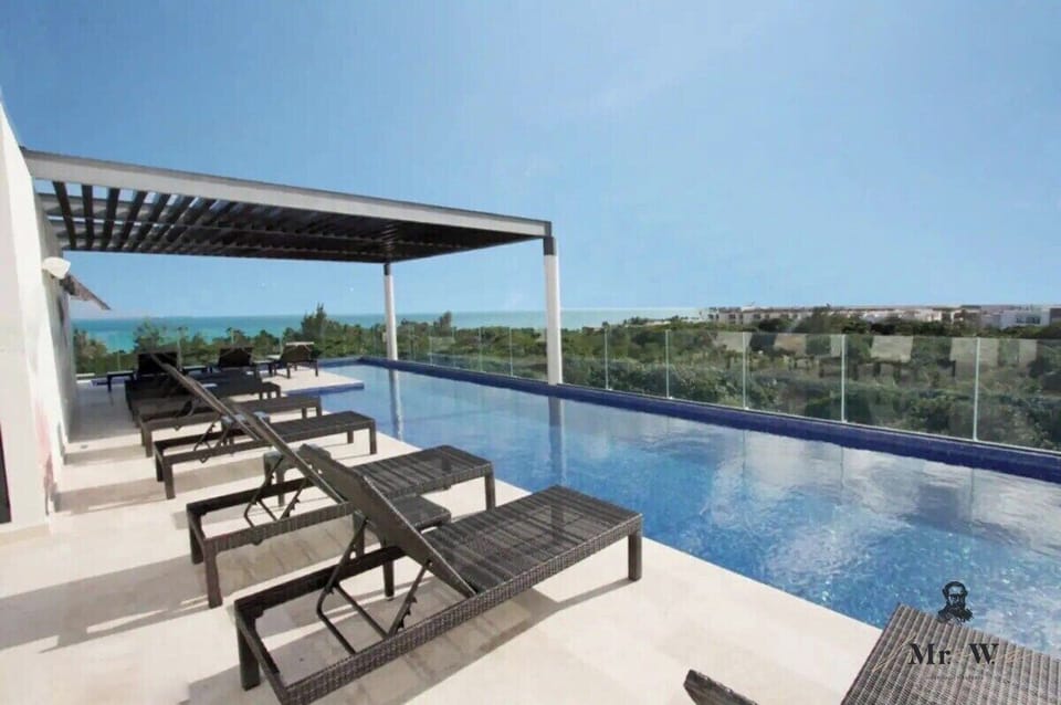 Lounge by the pool with breathtaking ocean views.