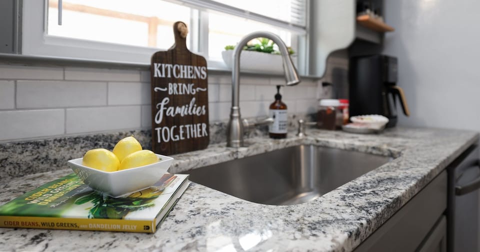Kitchen with large stainless steel sink and granite countertops