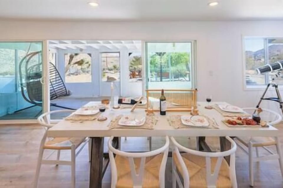 Dining Room with desert views from large sliding glass doors to enclosed patio and egg chair