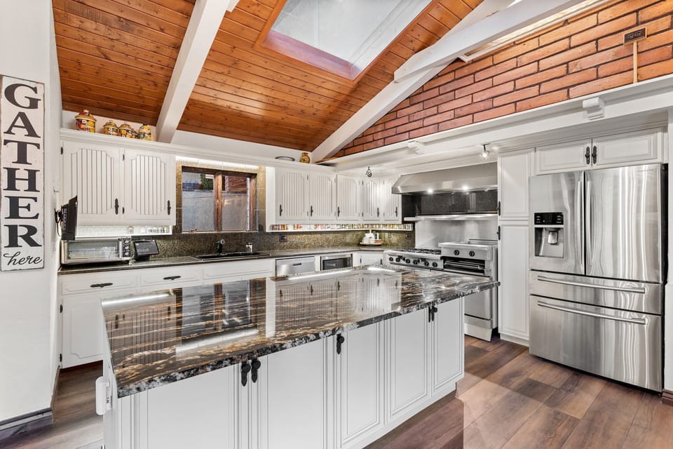 View of Kitchen island and huge stove