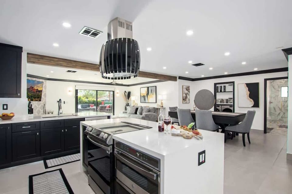 Fully equipped kitchen stocked with your basic cooking essentials, and stainless-steel appliances, bar seating, all connected to the formal and informal living areas and dining area.