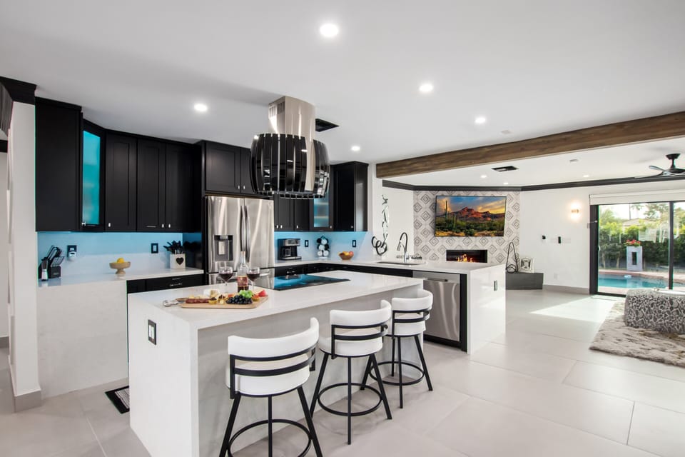 Fully equipped kitchen stocked with your basic cooking essentials, and stainless-steel appliances, bar seating, all connected to the formal and informal living areas and dining area.