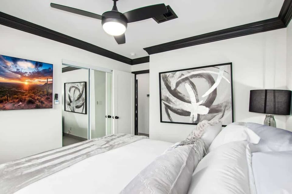 4th bedroom with Queen bed, smart TV, and designer furnishings.