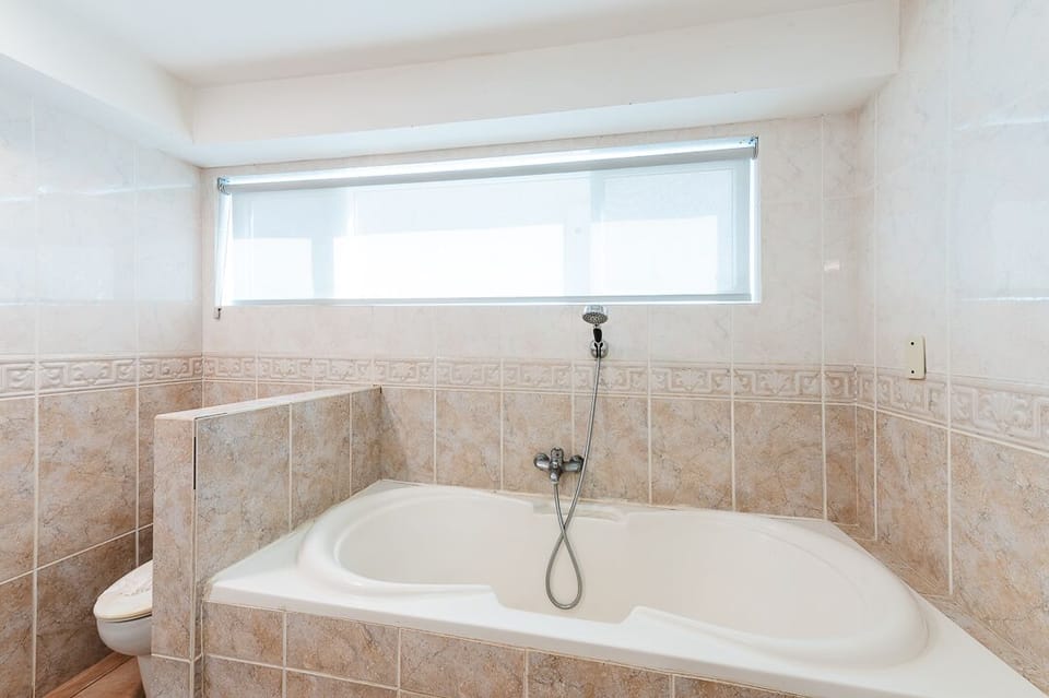 Relax in the stylish bath, featuring contemporary fixtures, ample space, and a clean, bright design—perfect for a stress-free family vacation in Tamarindo.