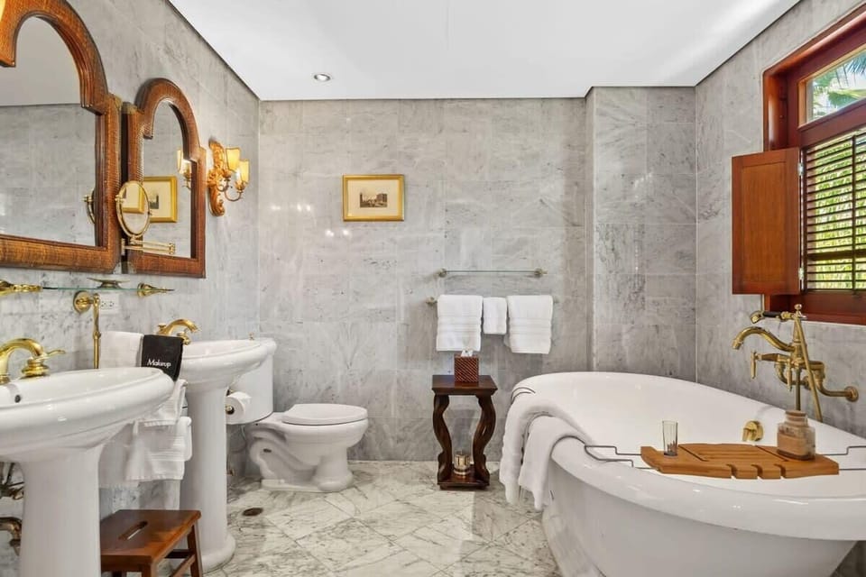 The master bathroom has two sinks, a bathtub and shower.