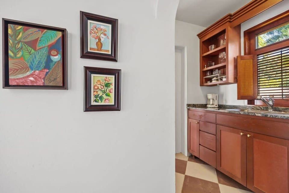 It offers a small refrigerator, toaster, microwave oven, a single burner portable stovetop, coffee maker, a blender, and basic pots and pans for simple cooking.