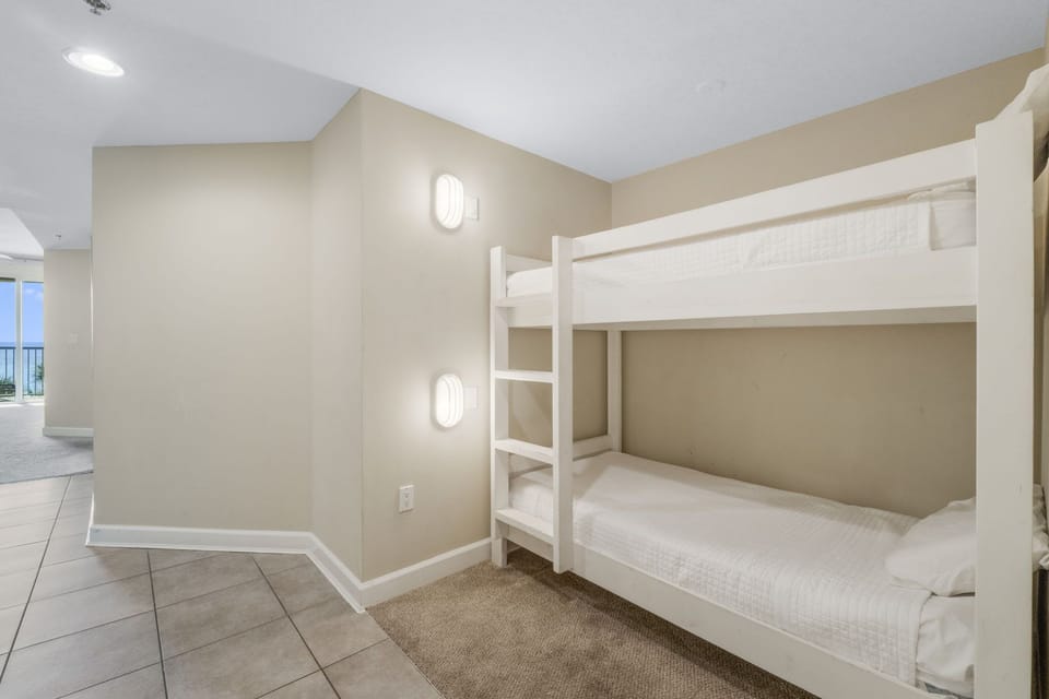 Compact bunk bed area with neutral tones and soft lighting