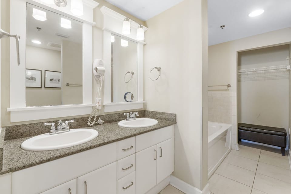 spacious bathroom with dual sinks and a large mirror
