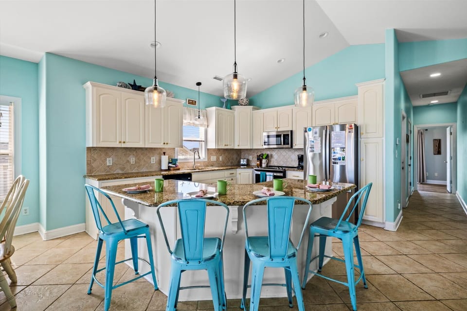 Gather around the table for laughter and shared meals in this inviting, coastal-inspired space.