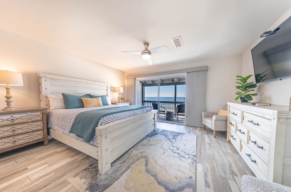 Master bedroom with a king size bed and private balcony.