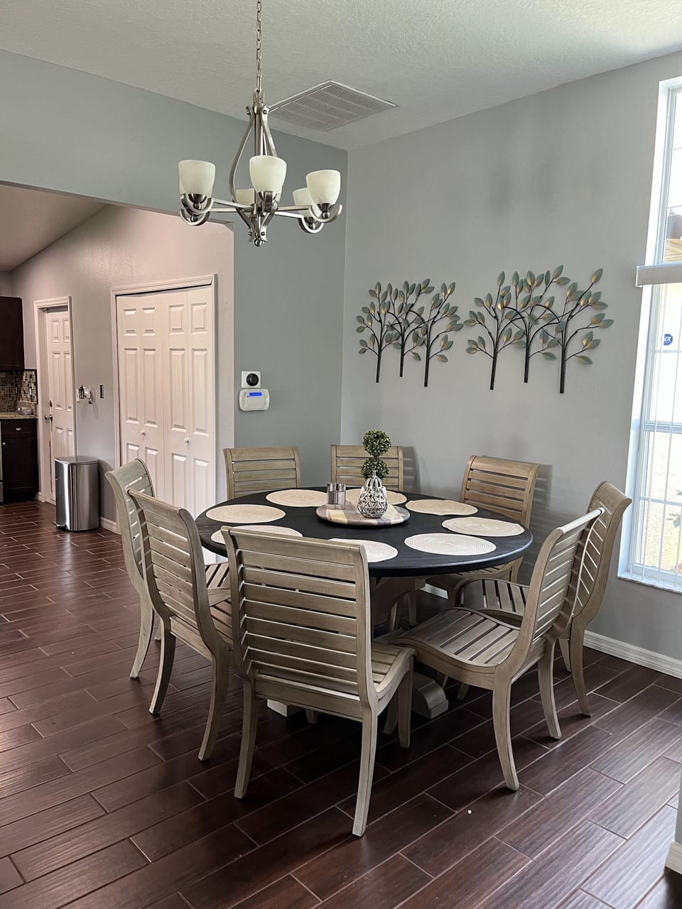 Dining area located near kitchen; seating for 8 guests.
