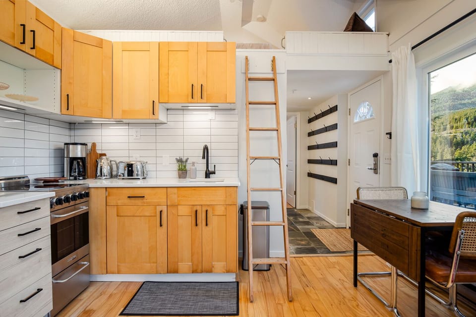 Kitchen and access ladder to secondary loft bedroom space
