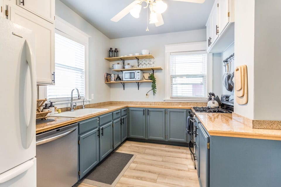 A modern kitchen with ample counter space, sleek appliances, and open shelving for easy access to cooking essentials.
